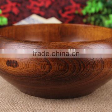Rice served with meat and vegetables on top wooden bowl
