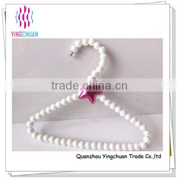 White plastic pearl baby hanger