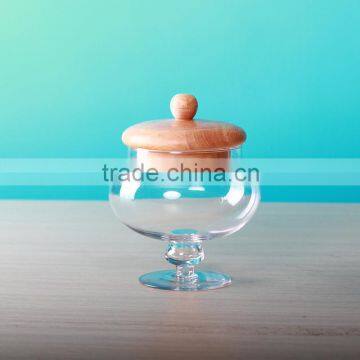 round glass jars and wooden lids with stemmed