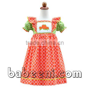 One of the Thanksgiving smocked dresses with pumpkin patterns