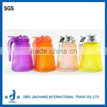 Colorful glass honey jars with plastic handle lid