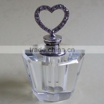 small empty crystal perfume bottle with jewelled metal alloy top
