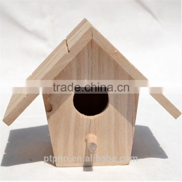 Small decorated wooden bird house for hanging inside and outside