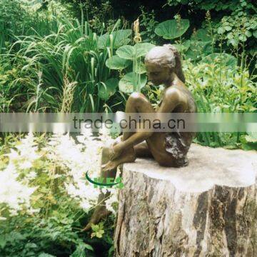 Bronze ballerine sculptures in grassland