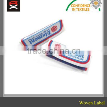 Brand name woven clothing label with center fold