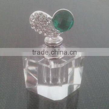 small empty clear crystal perfume bottle with jewelled metal alloy top