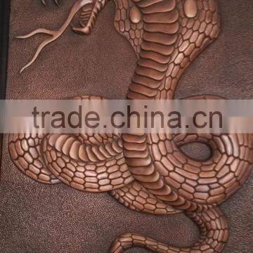 large snake sculpture wall relief