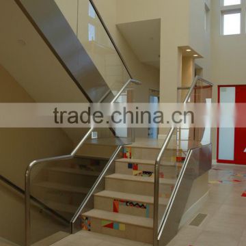 glas and stainless steel stair closed wood riser and wood tread and frameless glass railing