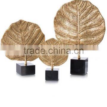 gold plated round leaf with black marble base sculpture