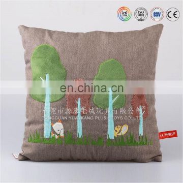 Plush cushion with embroidered tree