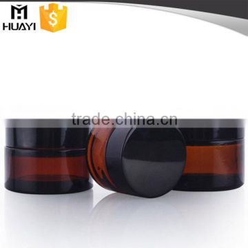 amber glass jar with black plastic cap for cosmetic cream