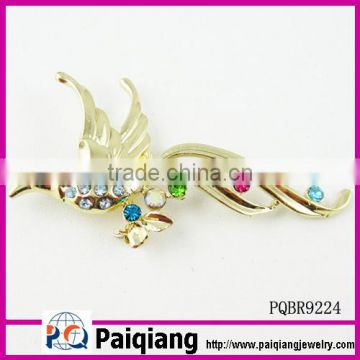 gold plated bird design with colorful rhinestone brooch