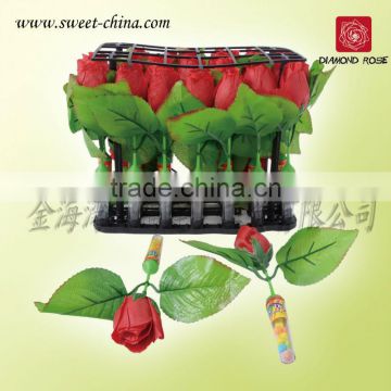 Red rose with candy in tray
