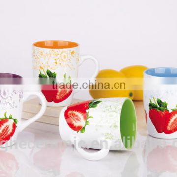 Handmade pottery coffee cups with sweet fruit designs