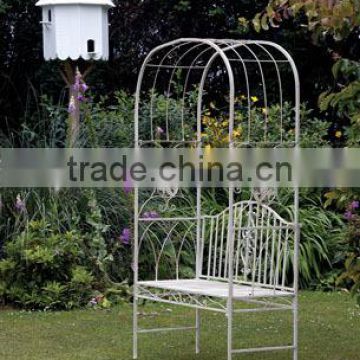 Decorative artistic wedding metal arch with bench