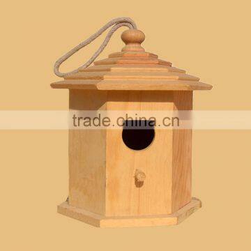 wooden bird house with water hyacinth roof