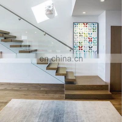 Design stair with floating treads in wood and structural glass balustrades