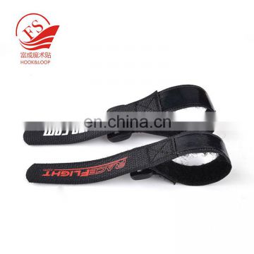 Hook and loop strap with rubber backed anti-slip band