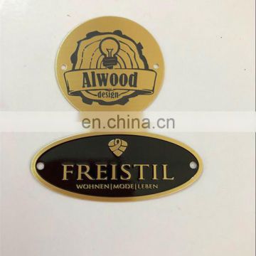 Oval engraved brass logo tag