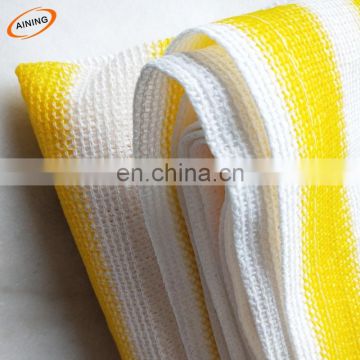 White and yellow HDPE balcony net with grommets
