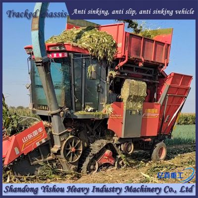 The modified track chassis of a corn harvester is muddy and stable without slipping