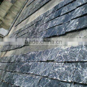 white vein in black marble slabs and tiles